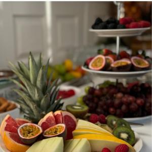 a table topped with lots of fruits on plates at Hotell Gillet i Köping in Köping