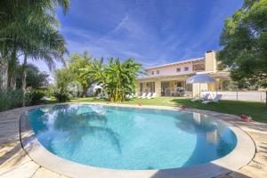 a swimming pool in front of a house at Villa Reginella in Lecce