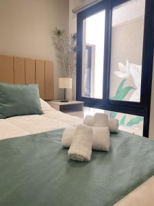 a bedroom with a large bed with towels on it at Hotel Caseros Salta in Salta