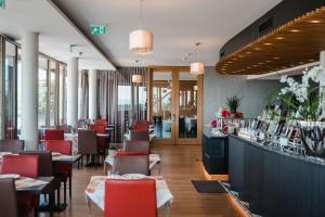 a restaurant with tables and chairs and a bar at Engener Höhe in Engen