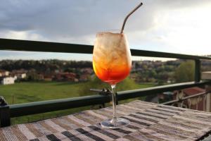a drink sitting on top of a wooden table at Appartamento del Sol, Free private parking, Free Wi-Fi in Varese