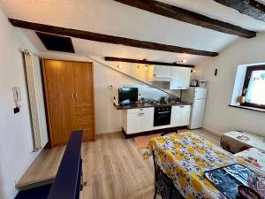a small room with a kitchen and a table in it at Muggia Studio 2 in Muggia