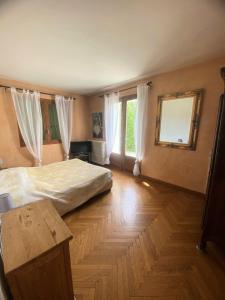 a bedroom with a large bed and a wooden floor at Résidence Lavoir - Maisons & Villas 424 in Villard-de-Lans