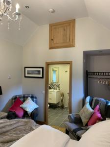 a bedroom with two beds and a chandelier at The Smiddy in Lochailort