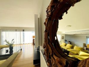 a living room with a large wooden sculpture of a living room at Penthouse with Private Pool in Athens
