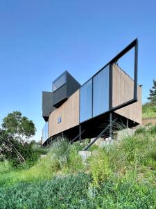 a house on the side of a hill at Casa en la Vega de pupuya in Navidad