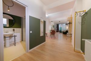 a hallway with green and white walls and a bathroom at Stil OldTown in Bucharest