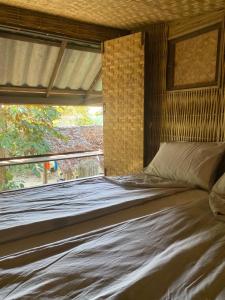 a large bed in a room with a window at i AM i Farm Stay in Mē Tamān +35 photos