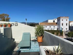 un balcón con sillas y plantas en un edificio en Romantic rooftop apartment with stunning sea and mountain views, en Marbella
