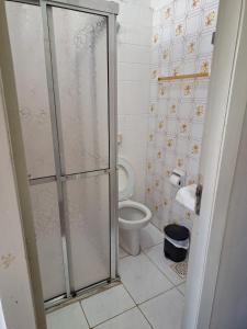 a bathroom with a toilet and a glass shower stall at Grande Hotel Torres in Torres +31 photos