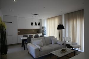 a living room with a couch and a table at Elvira Home San Gines AQ-104 in Santiago de la Ribera