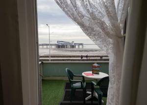 a room with a window with a table and a view of the beach at Monaco Hotel in Weston-super-Mare