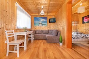 a living room with a couch and a table at Domki Hawana in Dąbki