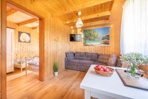 a living room with a couch and a table at Domki Hawana in Dąbki