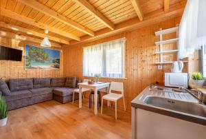 a living room with a couch and a table at Domki Hawana in Dąbki