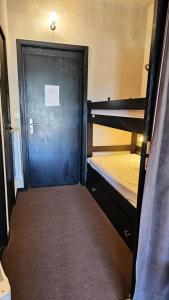 a room with two bunk beds and a door at Résidence Les Glovettes - Studio pour 4 Personnes 164 in Villard-de-Lans