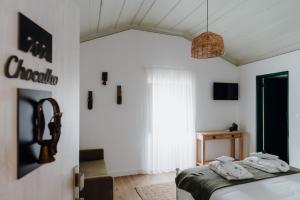 a bedroom with a bed with towels on it at Quinta do Louredo - Évora in Évora +56 photos