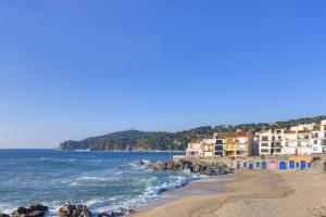 a view of a beach with buildings and the ocean at CANADELL BLOC B baixos 1ª in Calella de Palafrugell