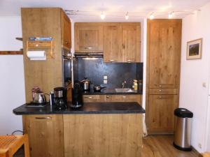 a kitchen with wooden cabinets and a counter top at Résidence L'enclave - 3 Pièces pour 6 Personnes 744 in Les Contamines-Montjoie