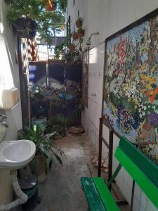 a bathroom with a sink and a painting on the wall at Casa Charmosa Verde-Azul in Paracuru
