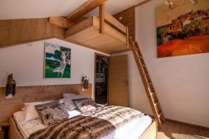 a bedroom with a loft bed and a ladder at Chalet KopÉrek - Chalets pour 12 Personnes 514 in Valloire