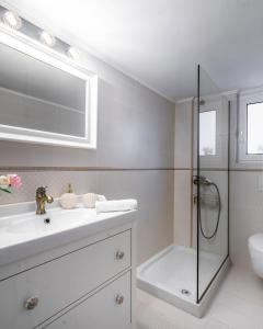 a white bathroom with a sink and a shower at Lovely 1 Bd apt in Kalithea with Balcony in Athens
