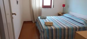 En eller flere senger på et rom på Appartamento vicino mare