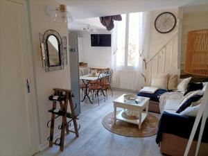 a living room with a couch and a table at Appartement Cosy à 20 mètres de la plage in Royan