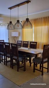 a dining room with a wooden table and chairs at Holidays Home Comporta in Comporta