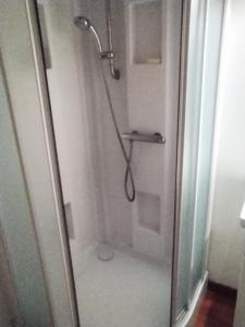 a shower with a glass door in a bathroom at Savoie, Simple mais confortable in Villard-sur-Doron