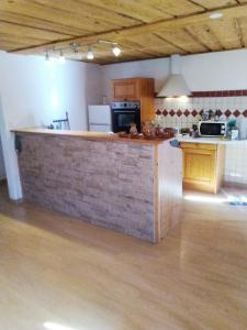 a kitchen with a wooden counter top in a room at Savoie, Simple mais confortable in Villard-sur-Doron