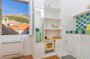 a bathroom with a window and a shower at Arty Apartments in the Heart of Dubrovnik by Irundo in Dubrovnik