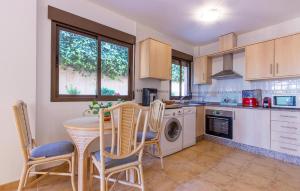 a kitchen with a table and chairs in a kitchen at Gorgeous Home In Cartagena With Wifi in Cartagena