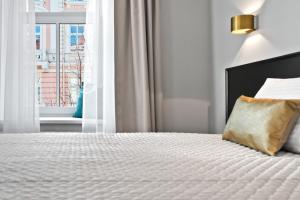 a bedroom with a bed with a pillow and a window at 15th Avenue in Vilnius