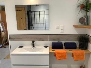 a bathroom with a sink and a mirror at St Pasha in Paillé