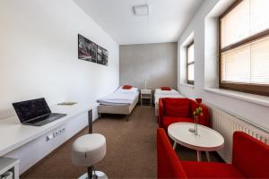 a hospital room with two beds and a laptop on a table at Penzion Dena in Jihlava