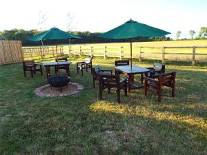 a group of tables and chairs with umbrellas at The Stableyard in Bedford