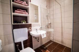 a small bathroom with a sink and a toilet at Hotel Dorrah in Tuzla +23 photos