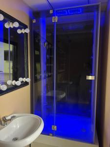 a bathroom with a glass shower with a sink at Hostel Krone GOK Zatishok in Kyiv