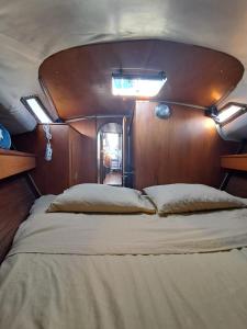 a large bed in the back of a boat at Bed & boat brezza del mare in Viareggio