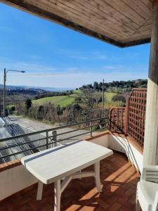 a white table on a balcony with a view at Fiori del Conero in Ancona