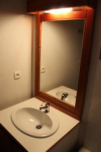 a bathroom with a sink and a mirror at Les Chalets De Superd Ancolie - APPARTEMENT DANS CHALET DE 30 LOGEMENTS EXPO VALLEE MAE-8434 in Le Dévoluy +18 photos