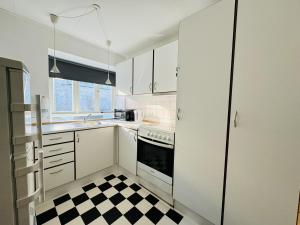 a kitchen with a black and white checkered floor at aday - Awesome Central ground floor apartment in Aalborg