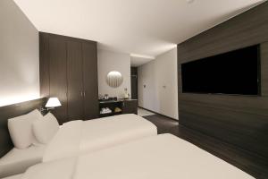 Postel nebo postele na pokoji v ubytování H Avenue Hotel Sangmu Branch