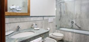 a bathroom with a sink and a toilet at Art Hotel Orologio in Bologna