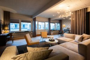 a living room with couches and chairs and a living room with at Hotel Maritime in Copenhagen