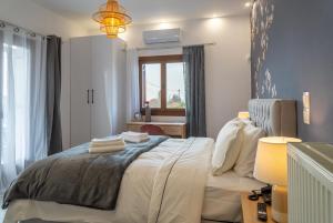 a bedroom with a bed and a window at Kostis Orange Resort in Volos
