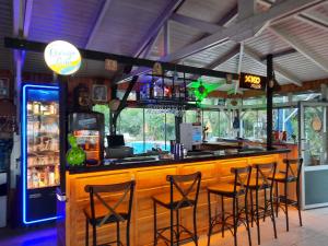 a bar in a restaurant with bar stools at Adrasan Maviay Hotel in Adrasan