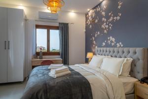 a bedroom with a large bed and a window at Kostis Orange Resort in Volos