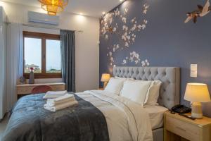 a bedroom with a large bed and a window at Kostis Orange Resort in Volos